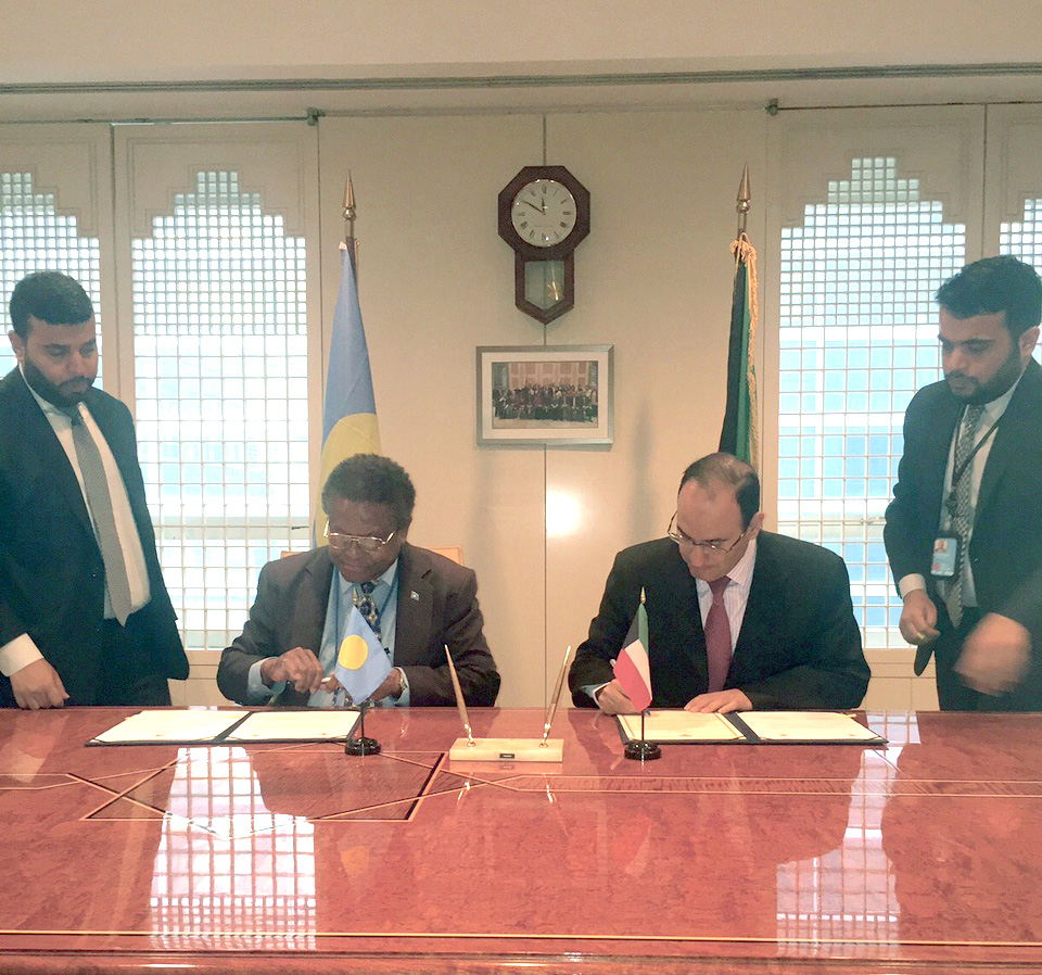 Kuwait's Permanent Representative to the United Nations Mansour Al-Otaibi and his Palauan counterpart Caleb Otto