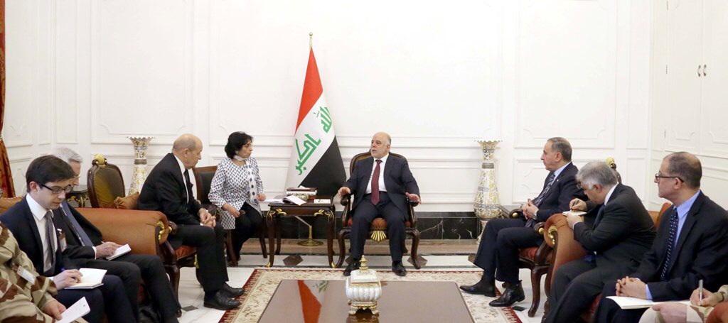 French Defense Minister Jean-Yves Le Drian during a meeting with Iraqi Prime Minister Haidar Al-Abadi