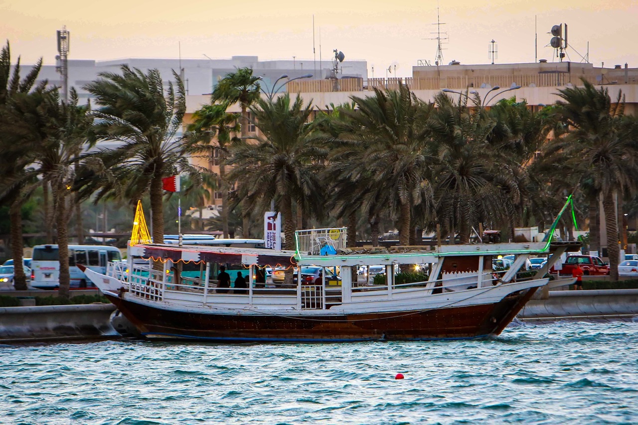 Magnificent view of wooden boats sailing on the waves of the Arabian Gulf, decorated with various colors