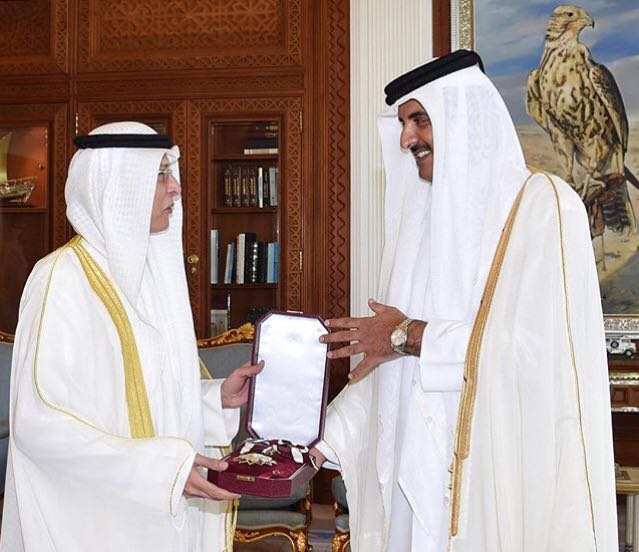 The Amir of Qatar Sheikh Tamim bin Hamad Al-Thani grants Kuwait's Ambassador Muteb Saleh Al-Mutawtah with the Sash of Merit