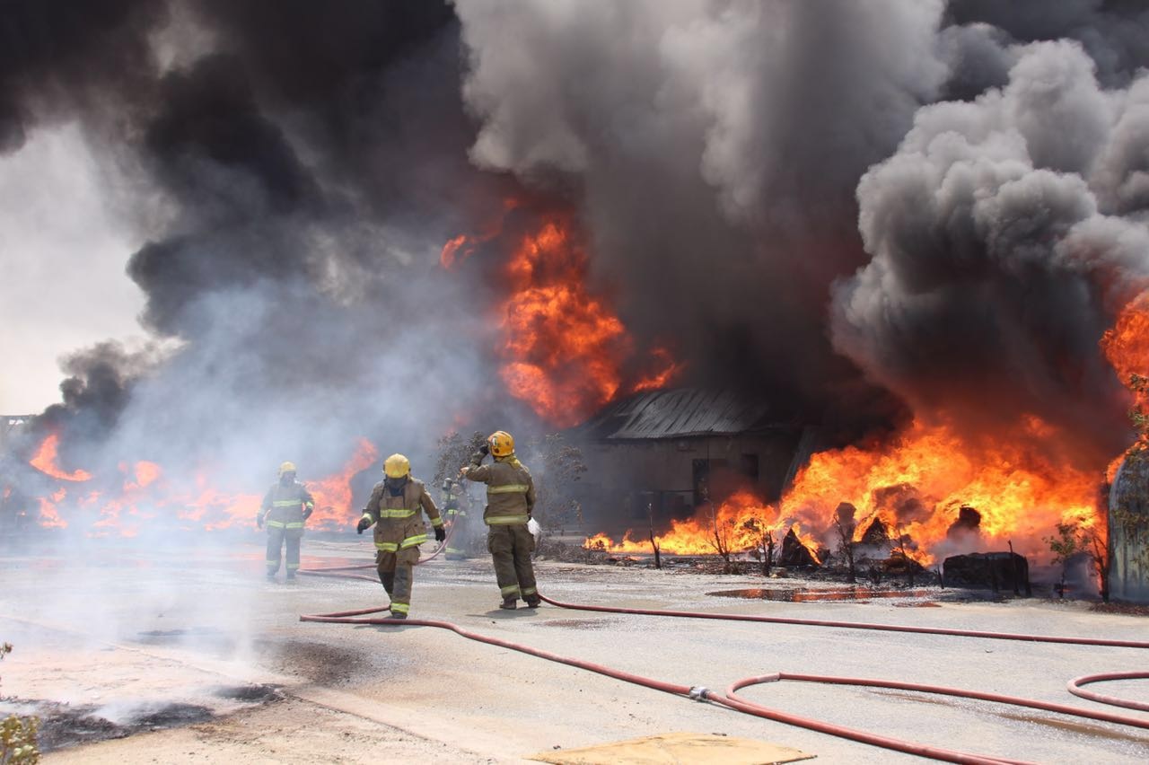 Firemen fight the fire erupted at sponge warehouse in Al-Shuaiba