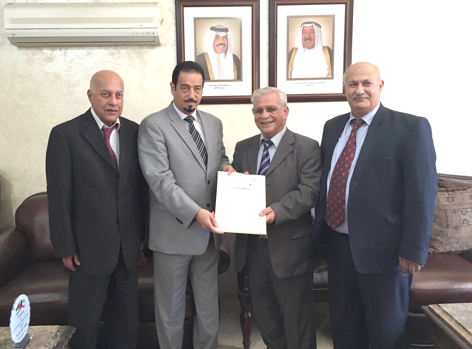 Kuwait Ambassador to Jordan Dr. Hamad Al-Duaij delivers financial assistance presented from the Zakat (alms) House to Al-Quds (Jerusalem) Open University