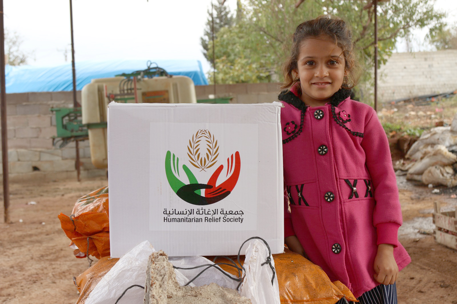 A Syrian refugee child receives aid from Kuwait's Humanitarian Relief Society (HRS)