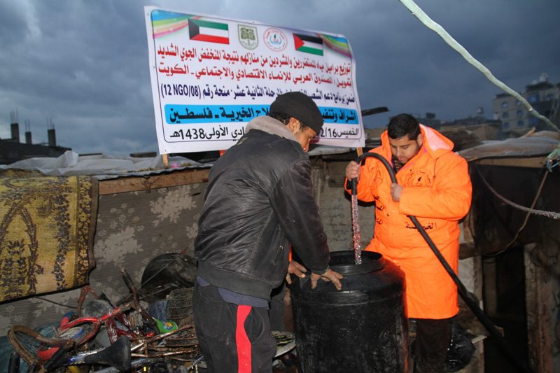 Kuwait's distribution of water to Palestinians who were affected by bad weather