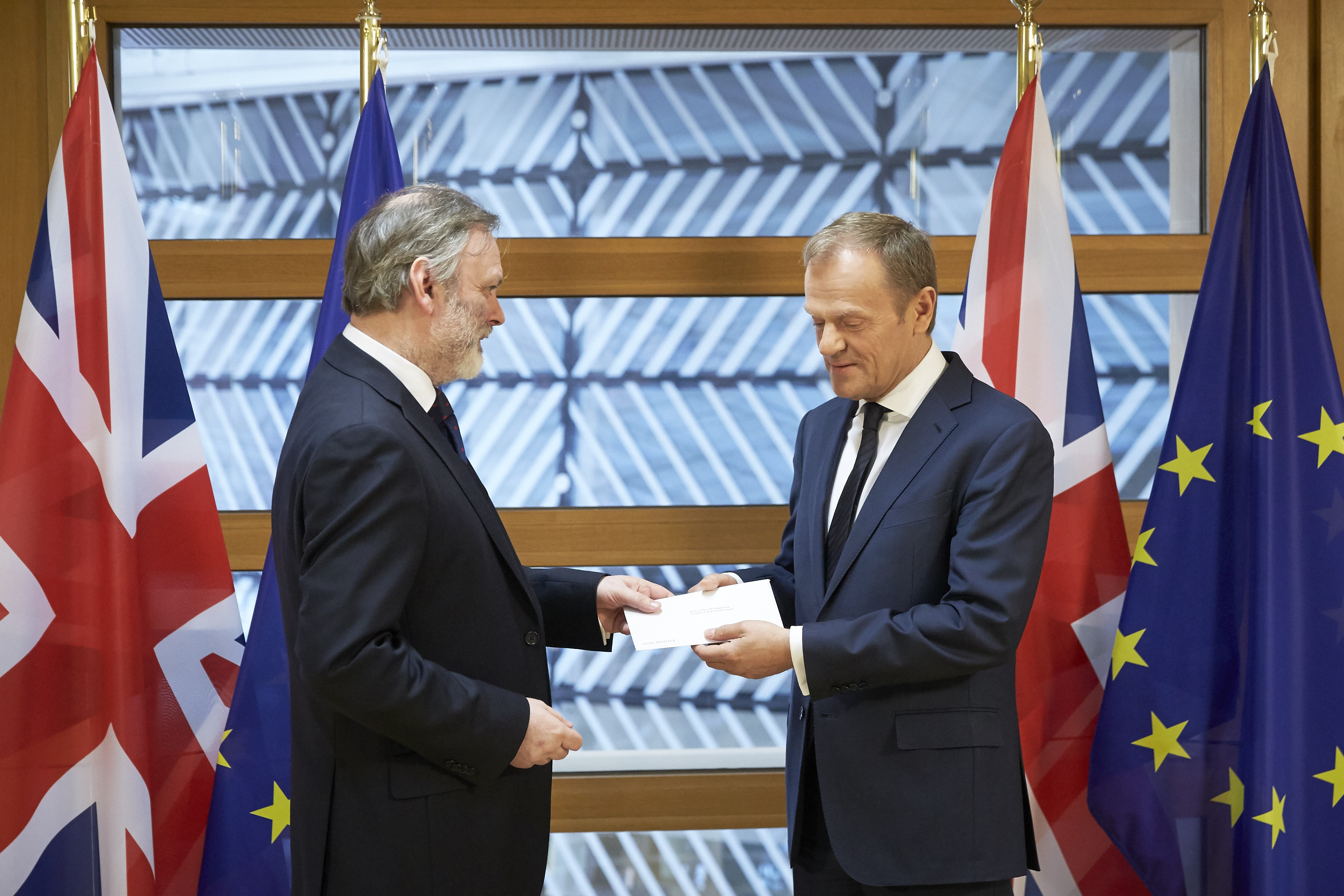 Sir Tim Barrow the UKs permanent representative to the EU hands the letter triggering Article 50  to the President of the European Council Donald Tusk.