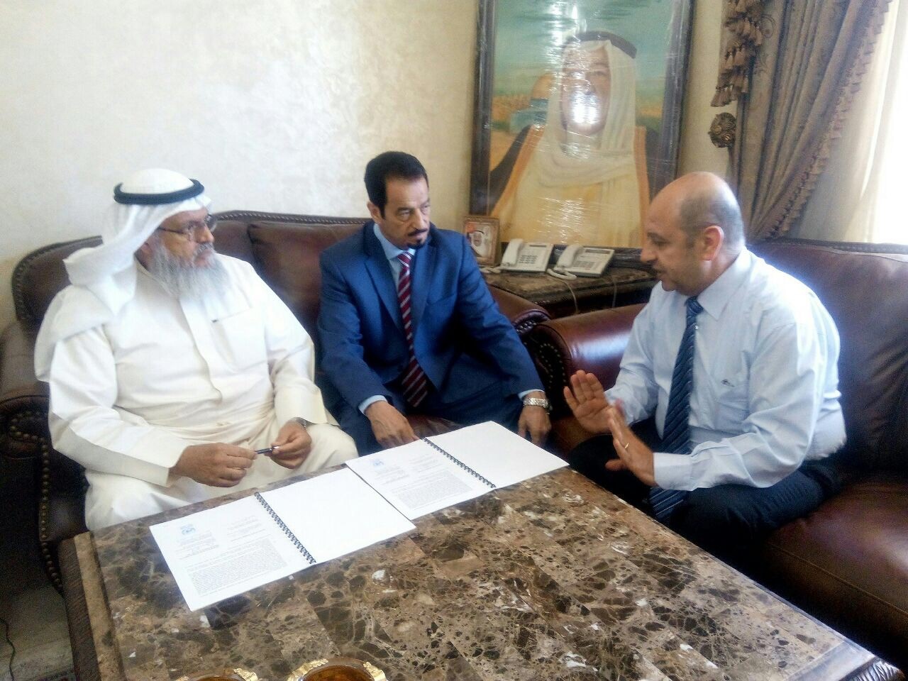 Kuwait's Patients Helping Fund Society's Chairman Dr. Mohammad Al-Sharhan, UNRWA Senior External Relations and Projects Officer Munir Mannah and Ambassador Hamad Al Duaij during the signing ceremony