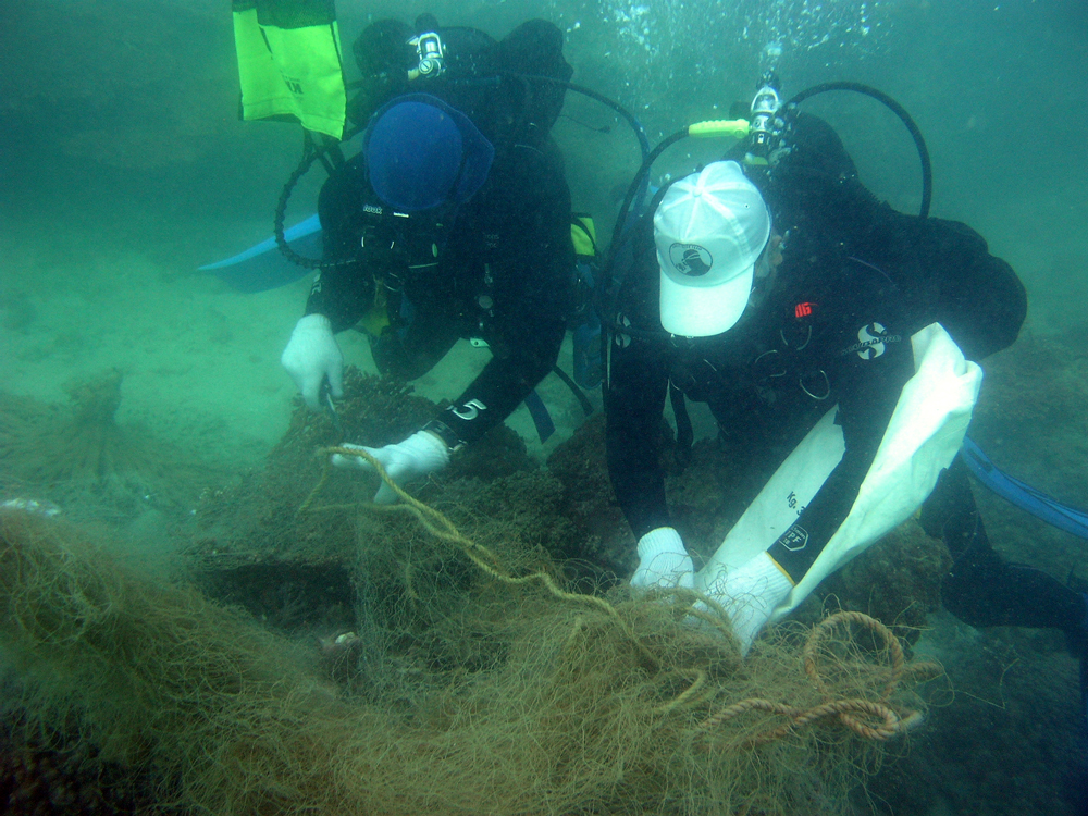 The Diving team removing fishing nets caught on corals