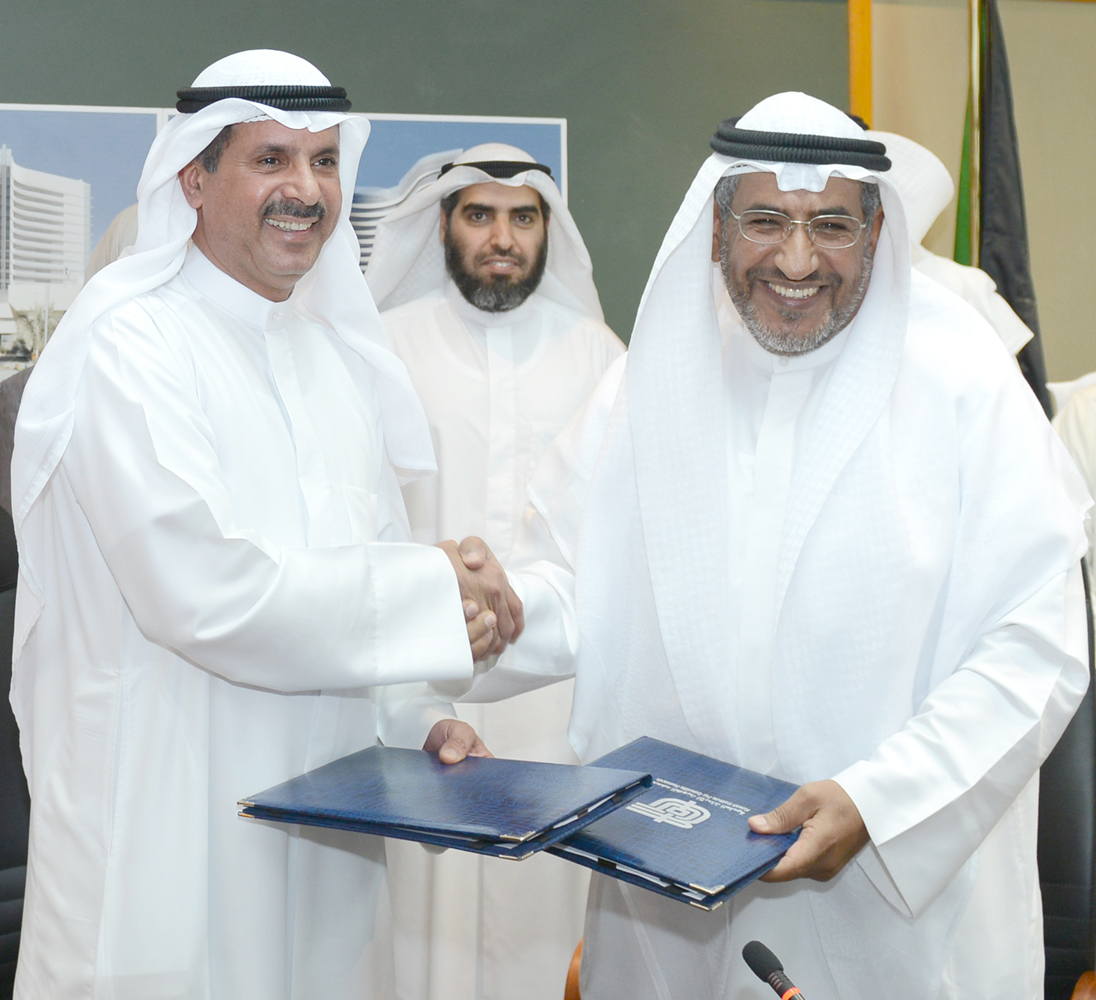 KISR Director-General Dr. Naji Mohammed Al-Mutairi and Dr. Ahmed Saleh Al-Athari from PAAET signing the cooperation agreement