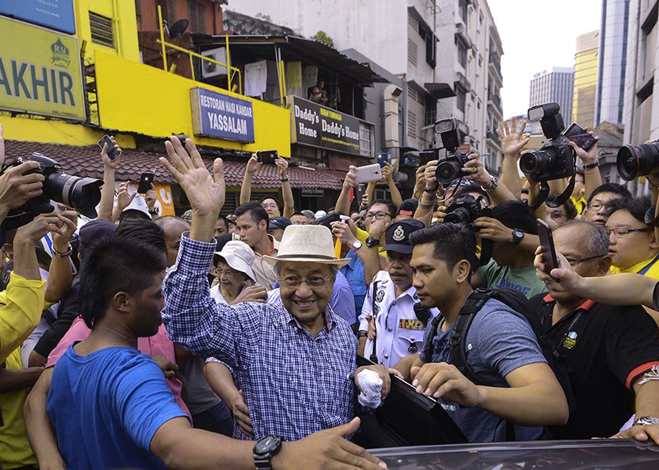 Former Malaysian premier Mahathir Mohamad, joining anti-government protesters for a second day on Sunday, called for a "people's power" movement to topple Prime Minister Najib Razak over a financial scandal.