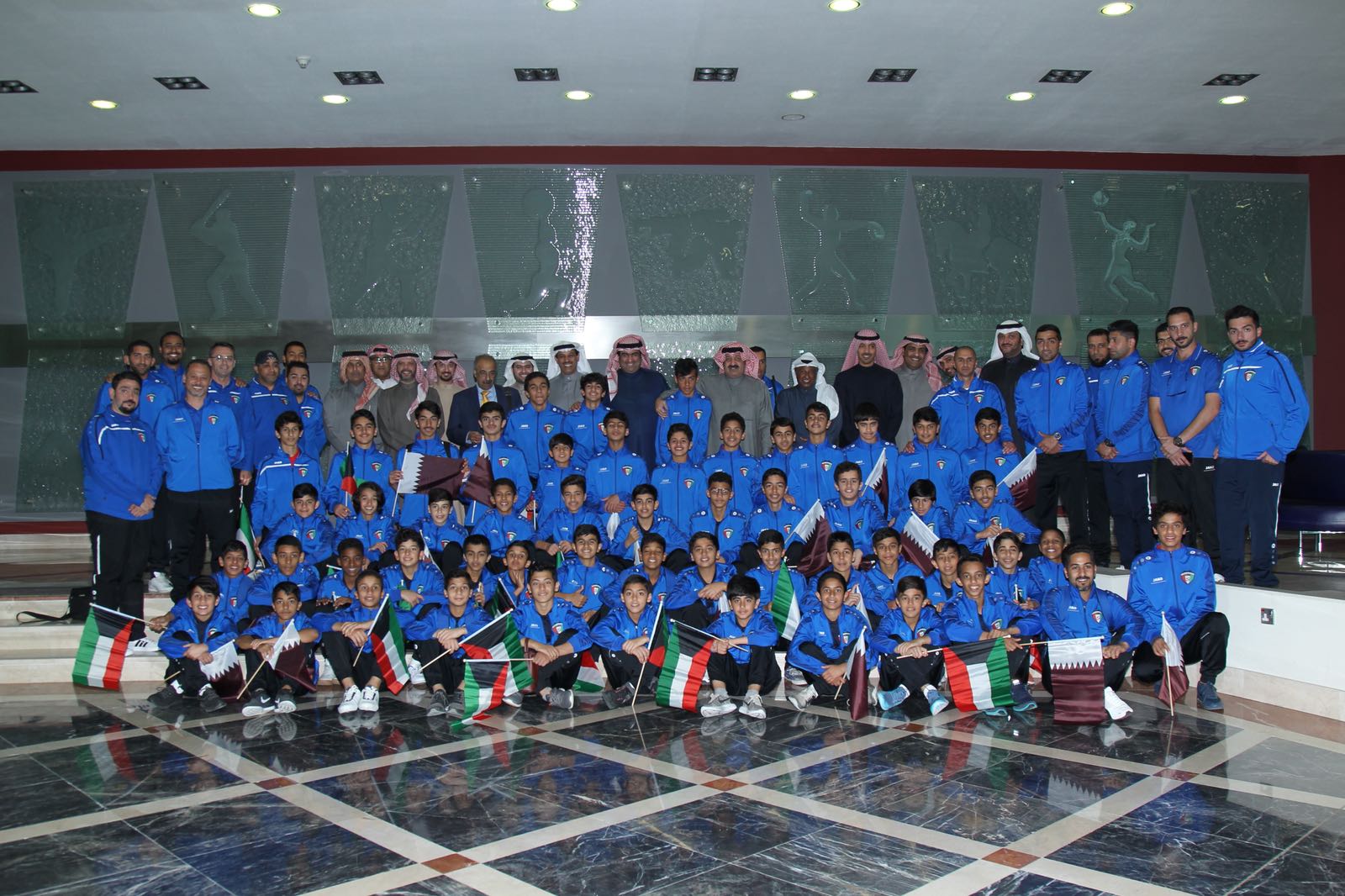 Kuwait's Commerce and Industry Minister and State Youth Minister Khaled Al-Roudhan meets two of Kuwait's junior national football teams