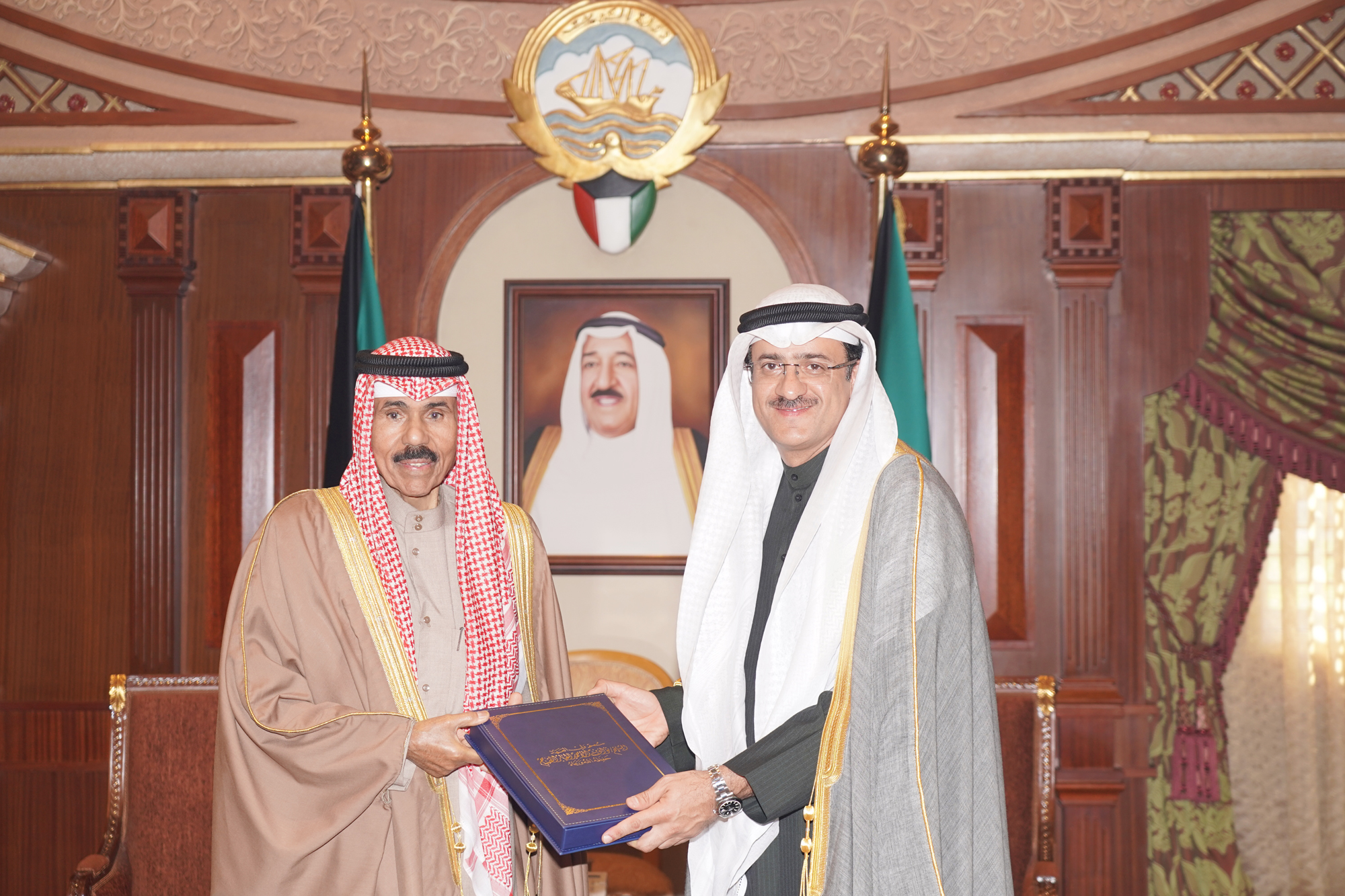 His Highness the Crown Prince Sheikh Nawaf Al-Ahmad Al-Jaber Al-Sabah receives Kuwait's Counsel General in Erbil Omar Al-Kanderi as he handed His Highness a book of Kuwait's humanitarian activities in Iraq since 2015