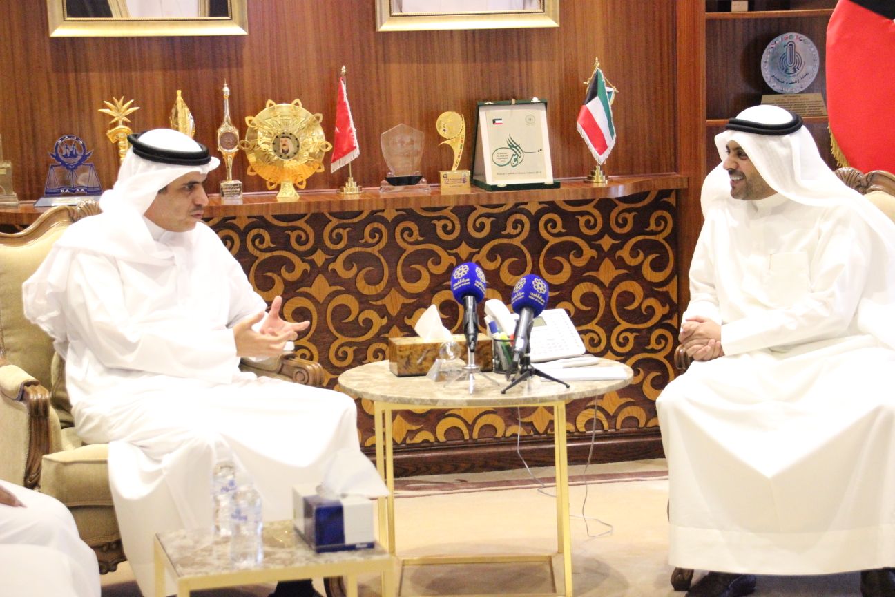 Kuwaiti Minister of Information Mohammad Al-Jabri meets with his visiting Bahraini counterpart Ali Al-Rumaihi