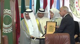 Secretary-General of the Arab League Ahmad Abul-Gheit hands representative of His Highness the Amir the Shield 
 