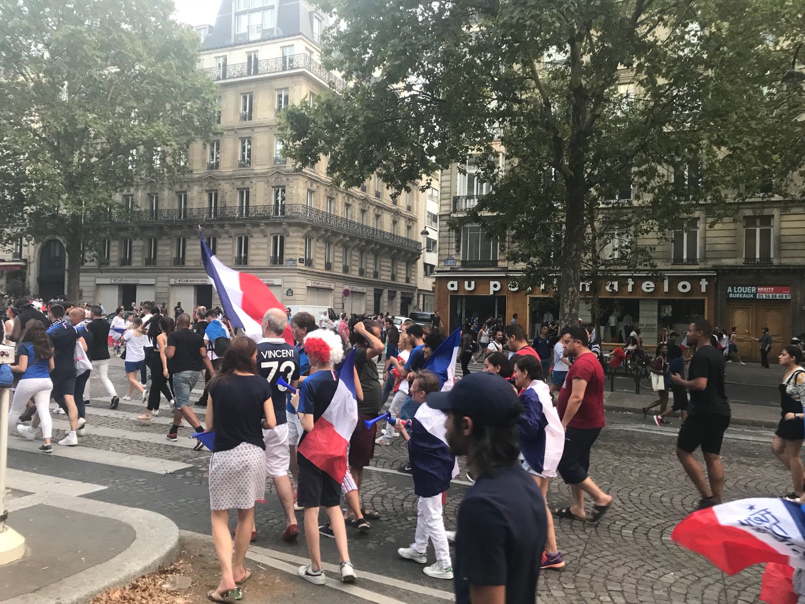 French fans pouring into Paris' Champs-Elysees Avenue