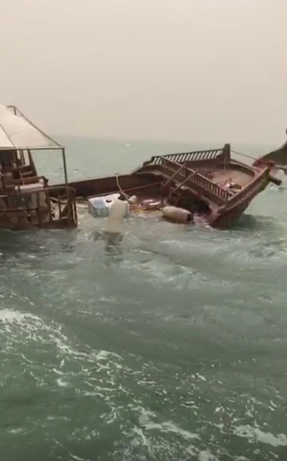 wooden boat capsized close to the Port of Doha
