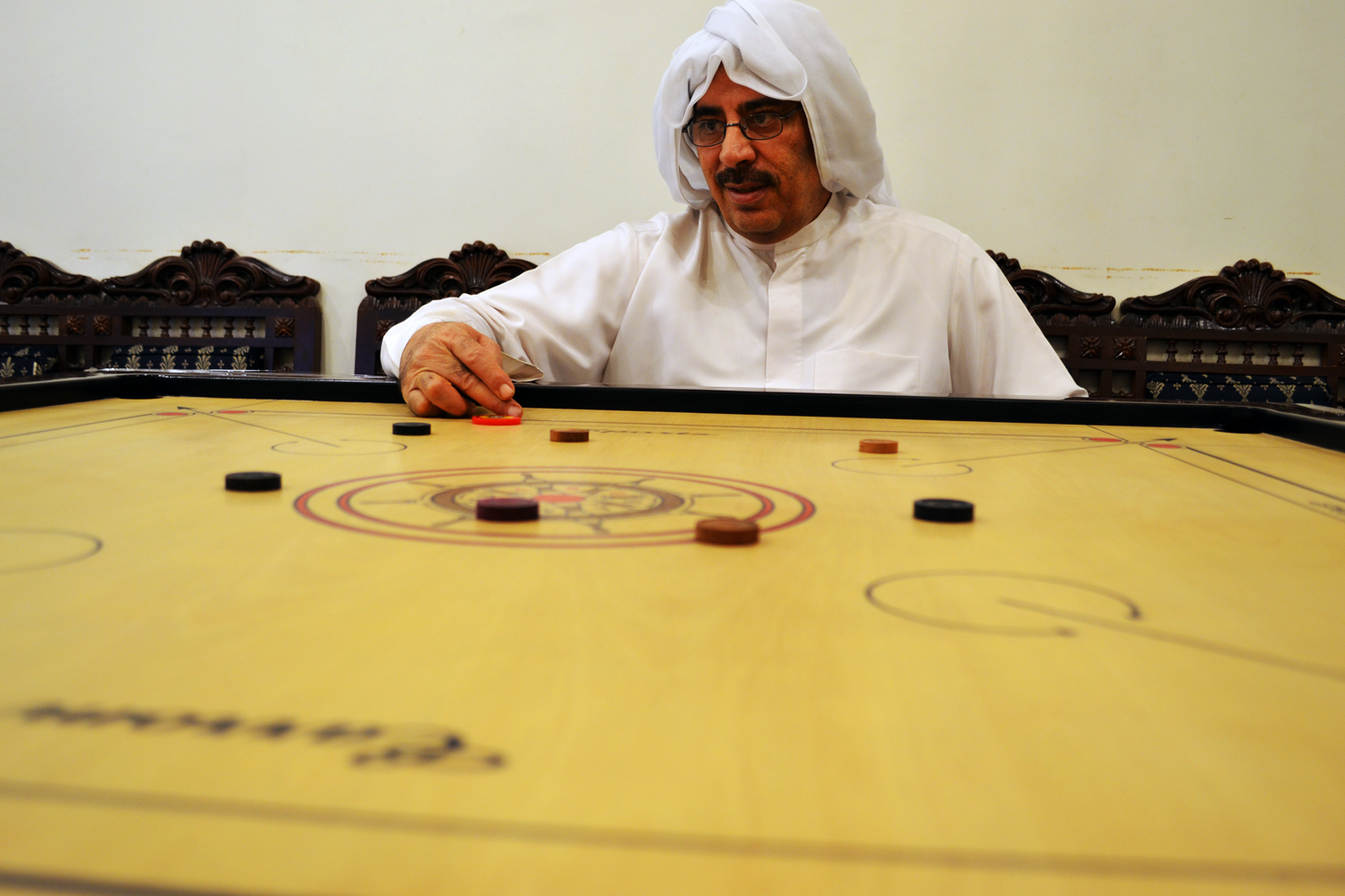 Carrom is a game consisting of a square-shaped wooden board, played similarly to billiard, and is very famous in the Gulf region