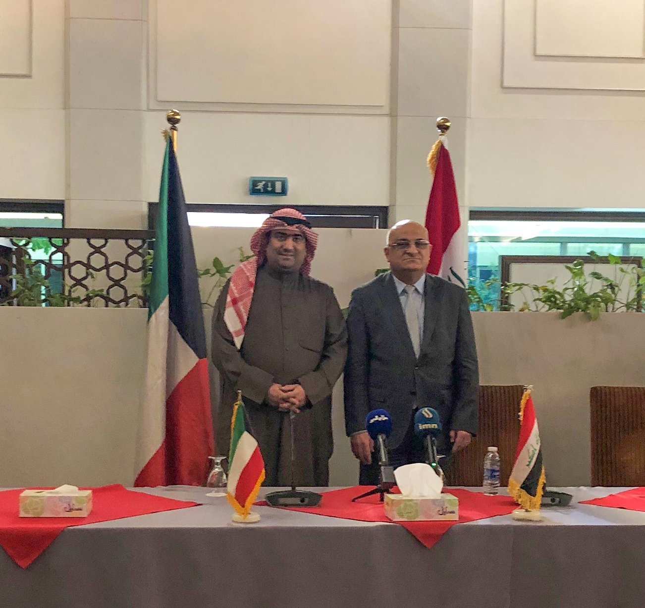 Kuwaiti Minister of Commerce and Industry, Khalid Al-Roudhan,  with his Iraqi counterpart Mohammad Al-A'ni