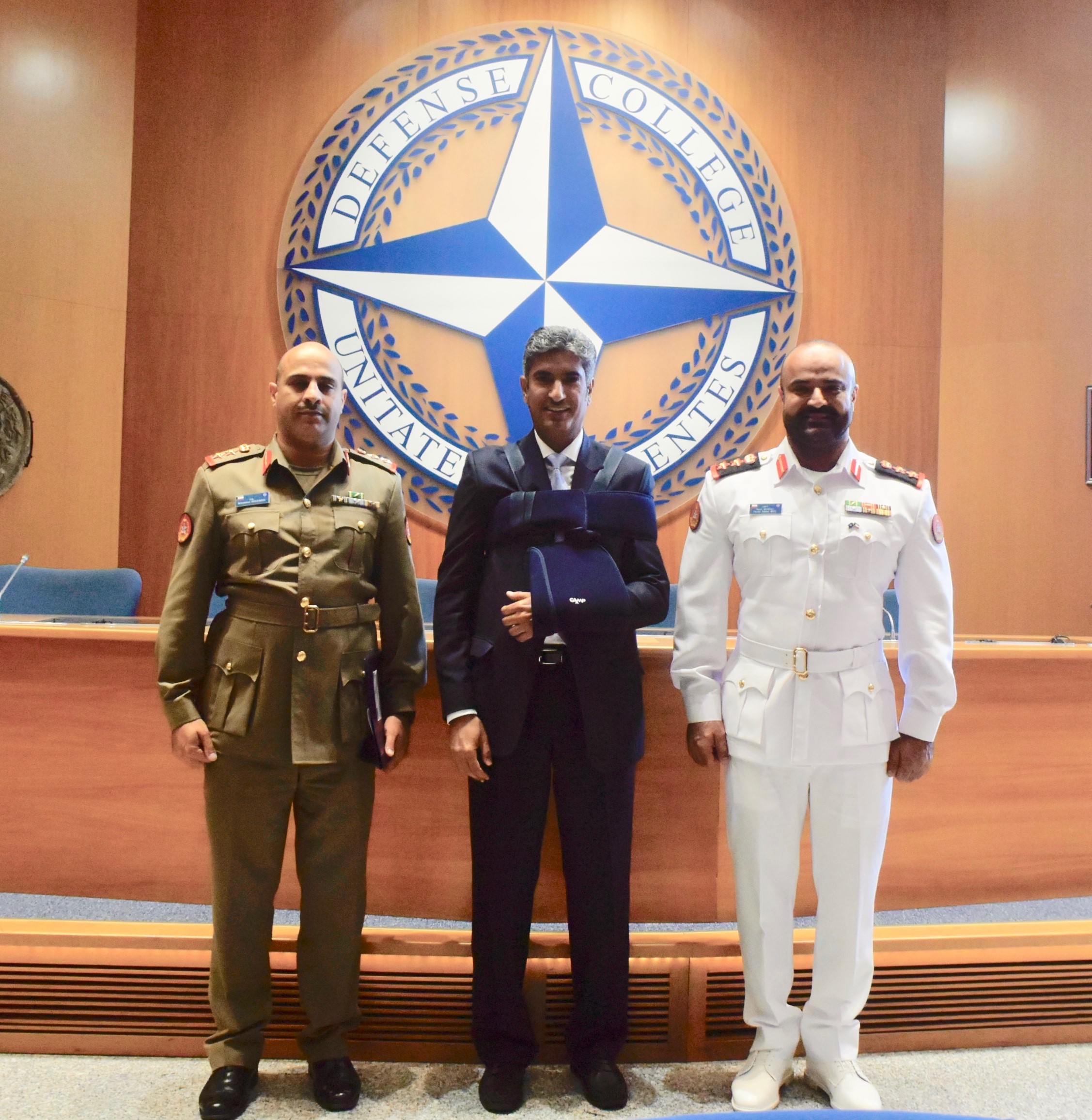 Kuwait Embassy to Italy Counselor Sami Al-Zamanan between the graduate and college advisor.
