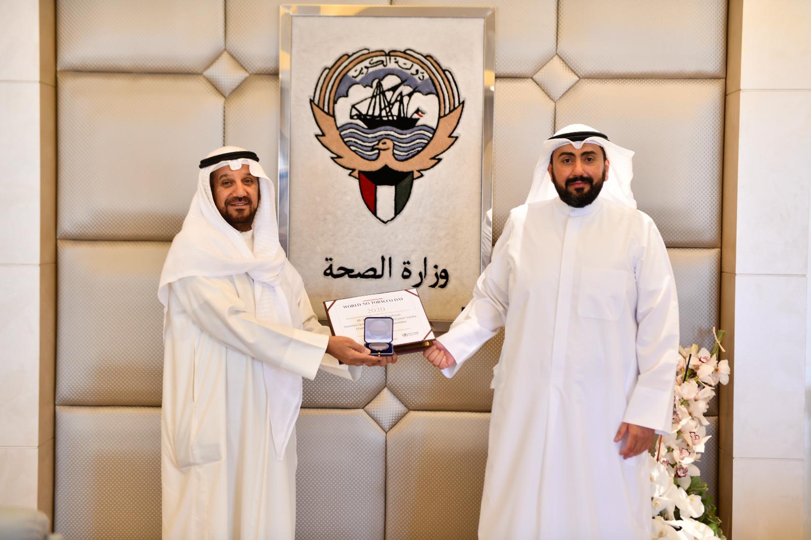 Health Minister Sheikh Dr. Bassel Al-Sabah honoring Secretary General of Kuwait Society for Preventing Smoking and Cancer