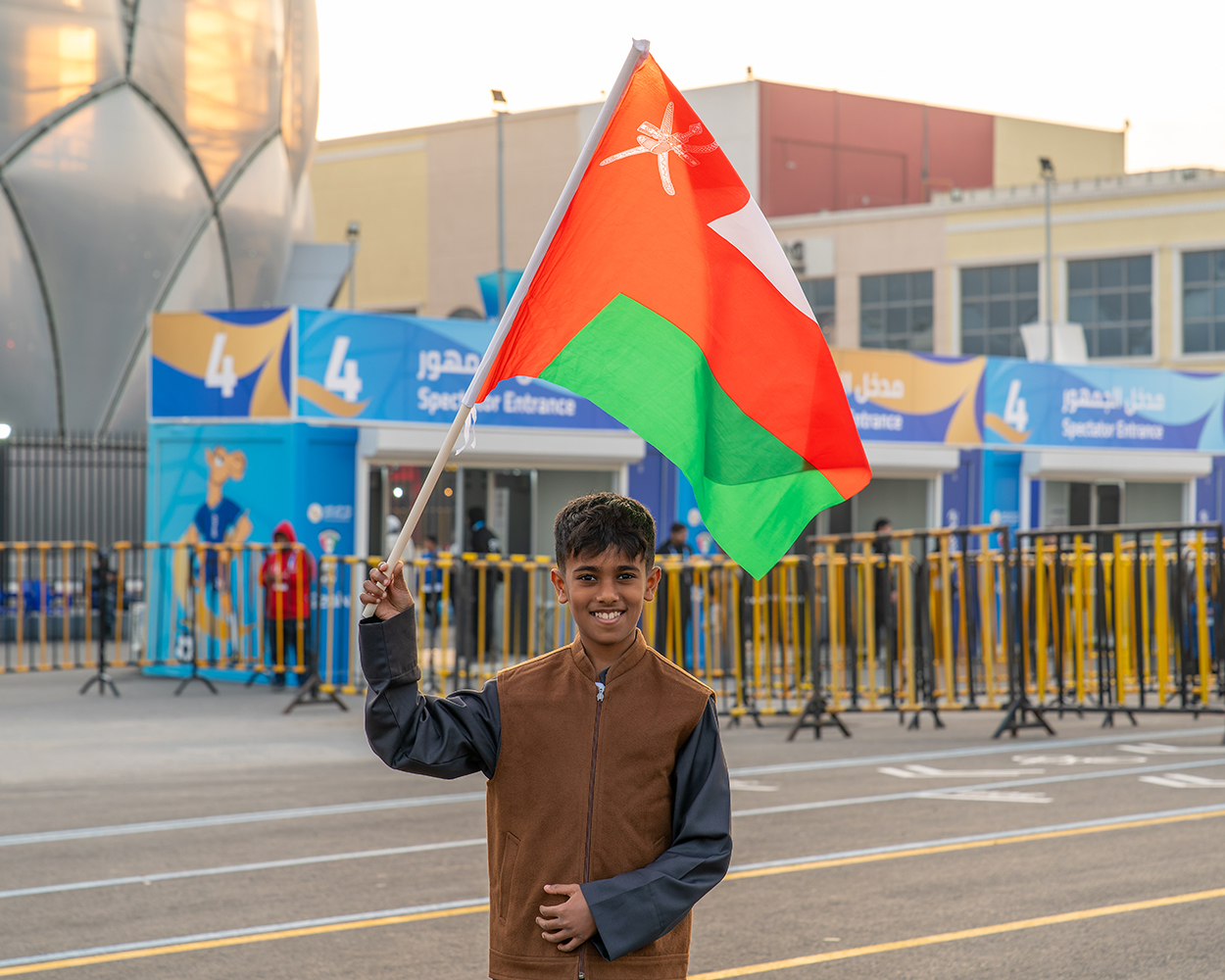 Omani fan cheering for his country