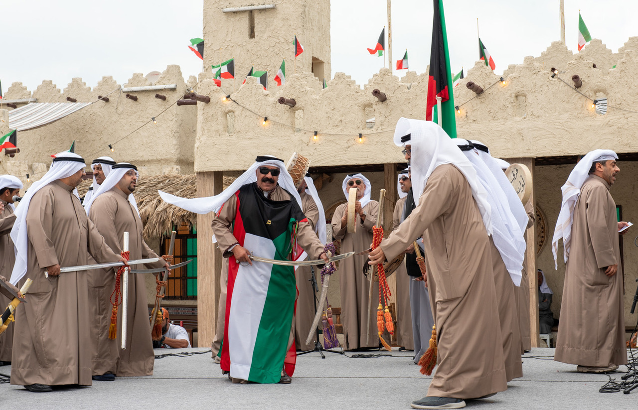 Kuwaiti folklore troupes performs the traditional Ardha Dance at Youm Al-Bahar Village