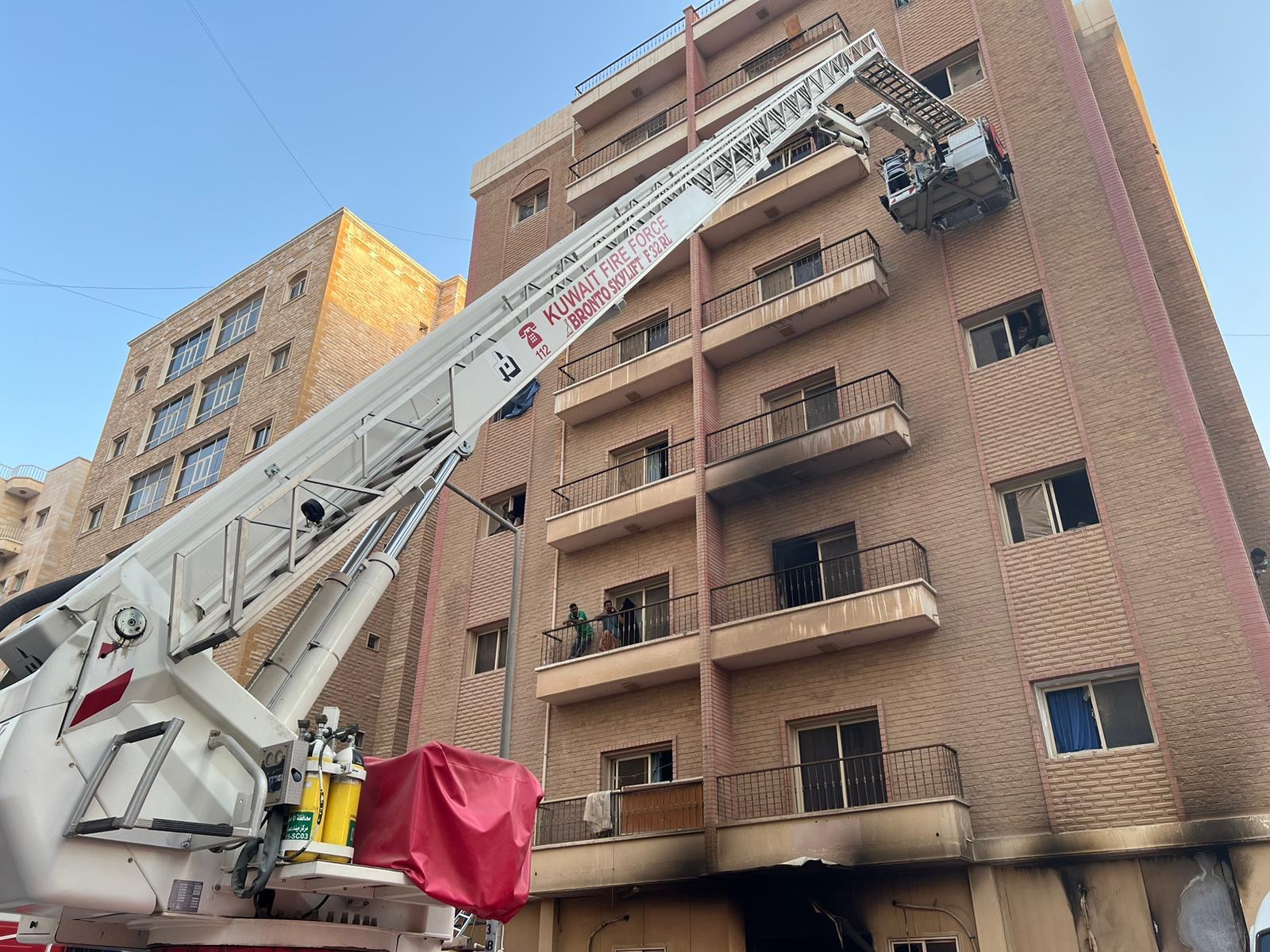 Kuwait Fire Force uses ladders to rescue occupants of bulding on fire