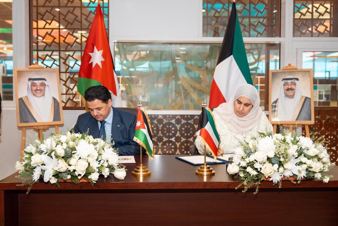 Kuwaiti Finance Undersecretary Aseel Al-Munifi and Jordan's Ambassador to Kuwait Sinan Al-Majali during signs a protocol amending