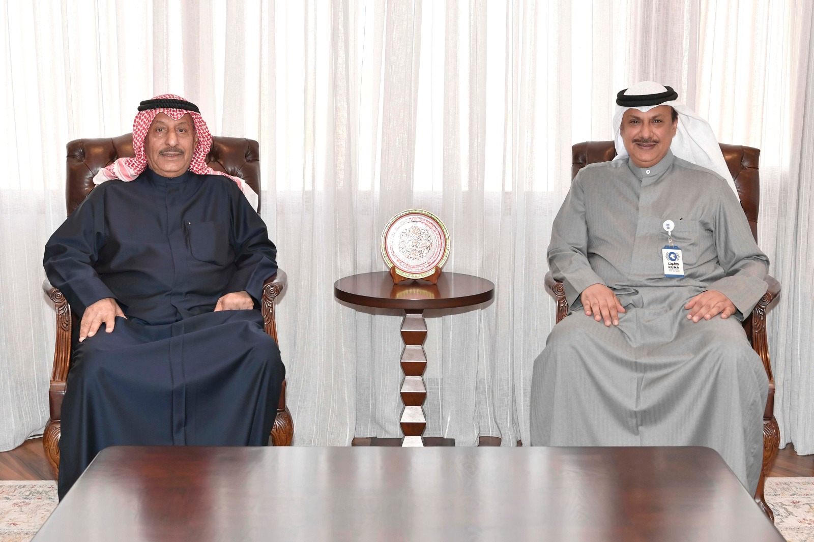 Acting Director General of KUNA Mohammad Al-Mannaei with Chairman of the Kuwait Red Crescent Society (KRCS) Khalid Al-Maqamis