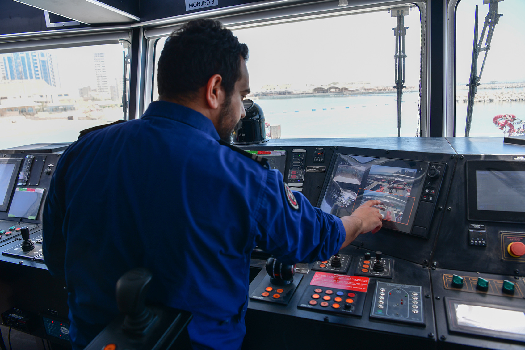 Marine Rescue member observes nautical chart.