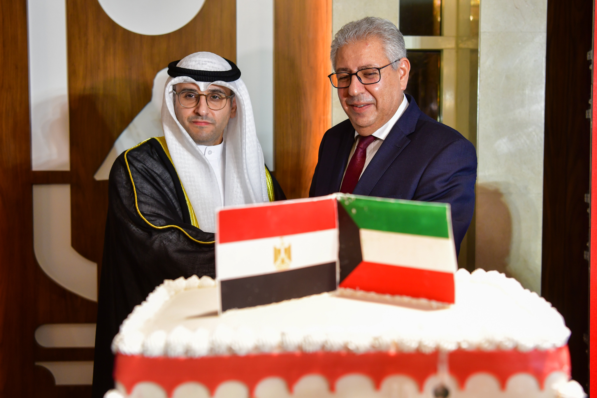 Kuwait's Minister of Municipal Affairs and Minister of State for Housing Affairs Abdul Latif Al-Mashari with Egypt's Ambassador to Kuwait Osama Shaltout
